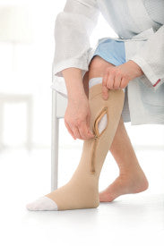 Person wearing beige compression socks from Compressionsale on a white background.