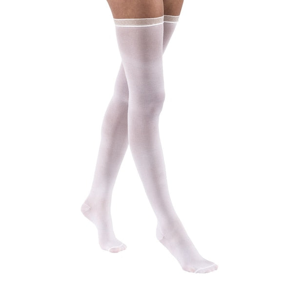 White thigh-high compression stockings with a thin white band on a white background – Compressionsale.