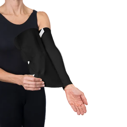 Person wearing a black arm sleeve on one arm against a white background