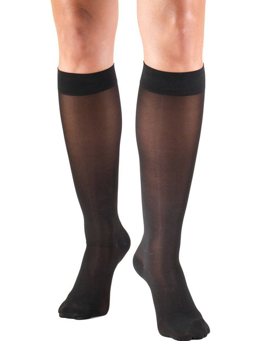 Black knee-high socks worn by a person on a white background