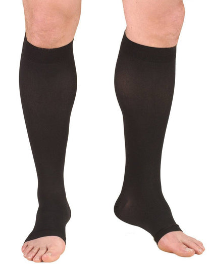 Black compression stockings being worn on a white background