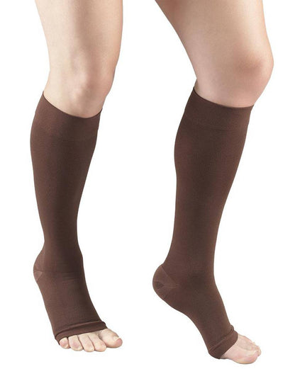 Brown compression stockings being worn on a white background