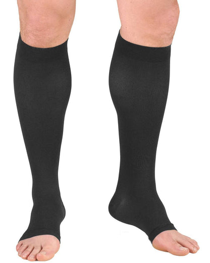 Charcoal compression stockings being worn on a white background