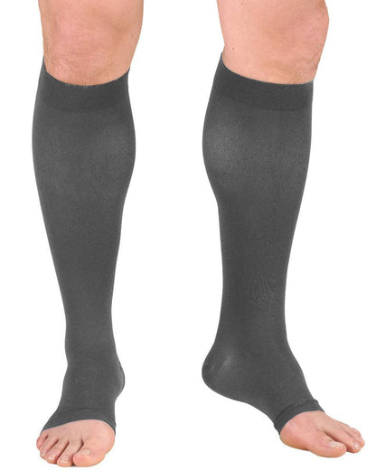 Gray compression stockings being worn on a white background