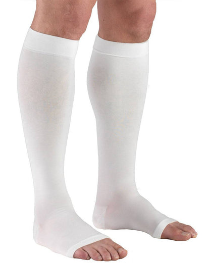 White compression stockings being worn on a white background