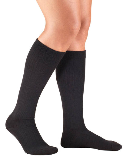Black knee-high socks worn by a person on a white background