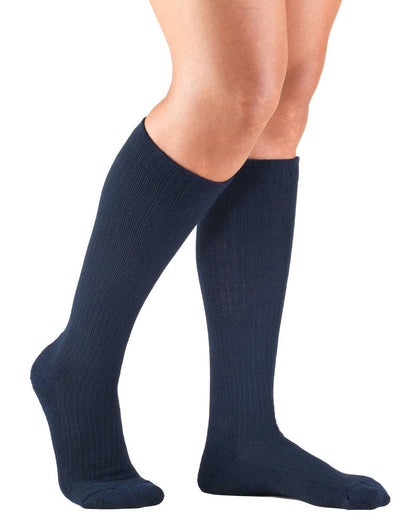 Blue knee-high socks worn by a person on a white background