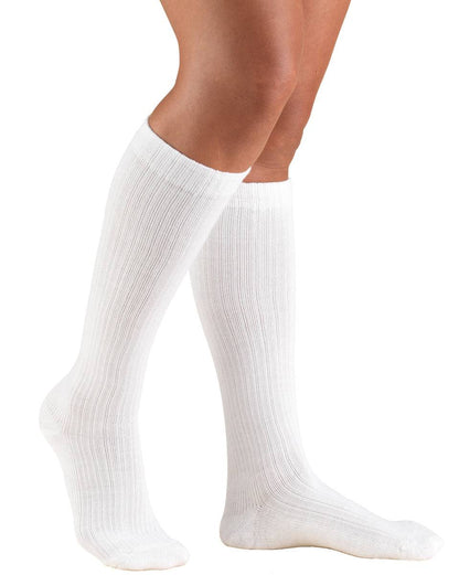 White knee-high socks worn by a person on a white background