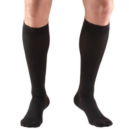 Black knee-high socks worn by a person on a white background in Trufrom