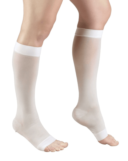 Ivory compression stockings being worn on a white background