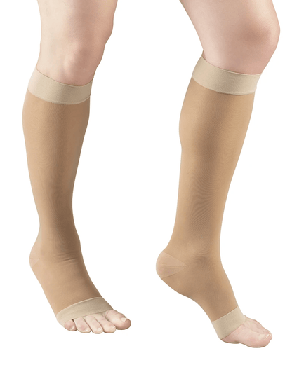 LIghtBeige compression stockings being worn on a white background