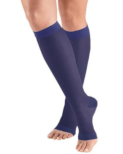 Purple compression stockings being worn on a white background