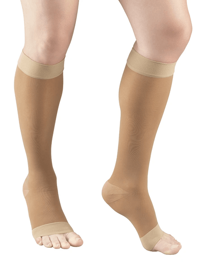 Warmbeige compression stockings being worn on a white background